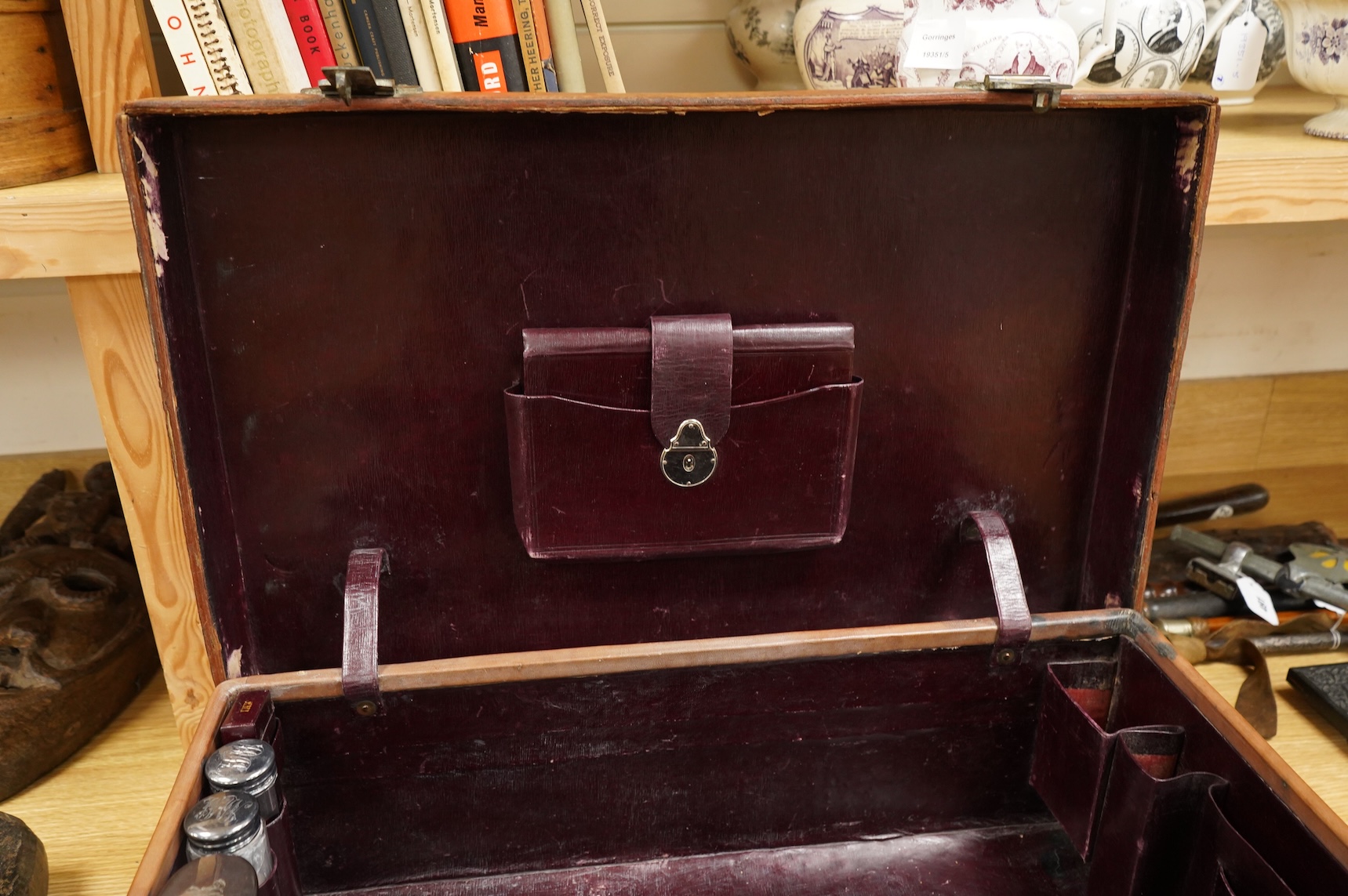 A leather toilet case with silver mounted contents, 61cm wide